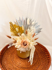 Dried flowers in gold plant pot 